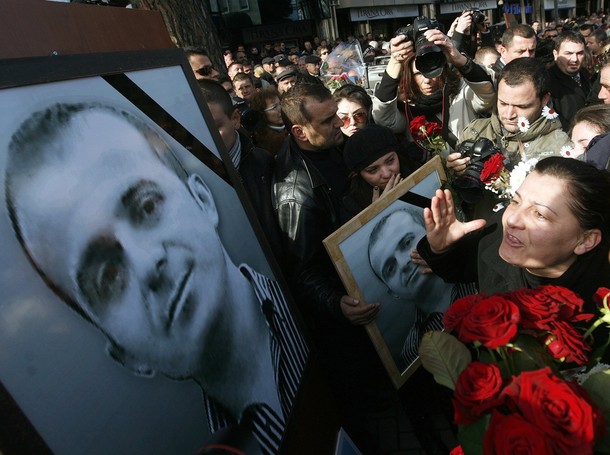 Relatives of one of the four people who were killed, cry in front of his portrait during a peaceful commemoration protest in Tirana January 21, 2012. The protest marks the first anniversary of opposition Socialist Party of Albania's rally on 21 January 2011 in which four people lost their lives. REUTERS/Arben Celi (ALBANIA - Tags: POLITICS ANNIVERSARY CIVIL UNREST)