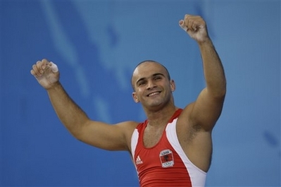 Erkand Qerimaj, of Albania, celebrates after a lift of 187 kilograms in the clean and jerk to finish first in the Group B of the men's 77 kg of the weightlifting competition at the Beijing 2008 Olympics in Beijing, Wednesday, Aug. 13, 2008. (AP Photo/Andres Leighton)