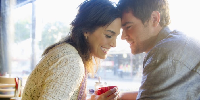 Couple holding hands in cafe